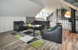 a living room with leather furniture and a table at Villa Utsikten in Kristinehamn