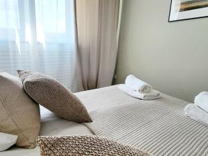 a bed with two towels sitting on top of it at Ostoja Orli Dziób C1 in Kal +37 photos
