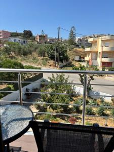 a balcony with a table and a view of a city at Artemis Home in Kastellákia