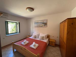 a bedroom with a bed with two towels on it at Villa Silentia in Lastovo