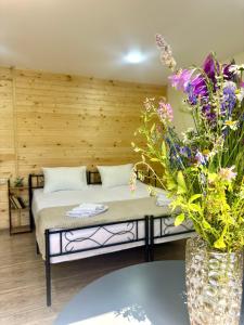 a bedroom with a bed and some flowers at Goshniver Rest House in Dilijan