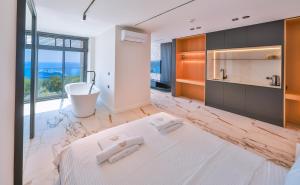 a bathroom with a large bed and a bath tub at Serenity Pearl in Kaş +152 photos