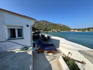 a balcony of a house next to the water at Riva Blue Silence -Seafront Retreat in Poseidónion