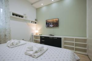 a bedroom with a bed with two towels on it at Apartman Vukota Pirot in Pirot +31 photos