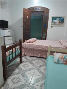 a bedroom with two beds and a mirror in it at Residencial mineiro in São Lourenço