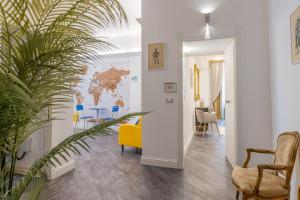 a living room with a yellow chair and a plant at Antiqua Domus in Rome