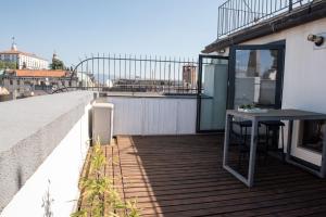 a balcony with a table on the side of a building at Penthouse with terrace Cavour 26 in Udine