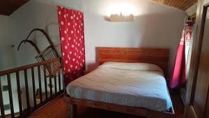 a small bed in a room next to a staircase at Locazione turistica Lou Bindel in Sampeyre
