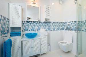 a bathroom with a sink and a toilet and a shower at Sirena Seaview Apartment - FREE PARKING in Varna City +19 photos