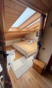 a attic room with a bed and a skylight at Outstandingfree in Holzleiten