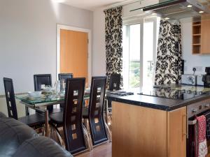 a kitchen and dining room with a table and chairs at Seaview in Llanelli