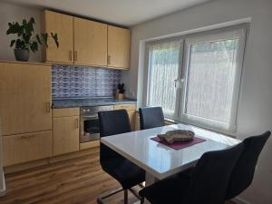 a kitchen with a table and chairs in a room at Kezara Living in Konz