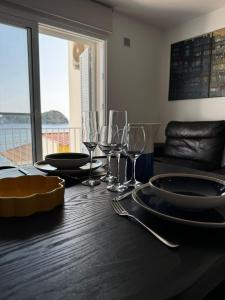 a dining table with wine glasses and plates on it at Vila do Ilhéu in Vila Franca do Campo +9 photos