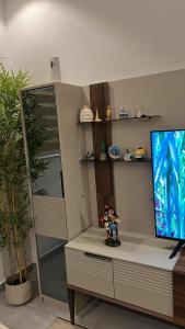 a living room with a tv and a table with a toy at Empire M in Kinshasa