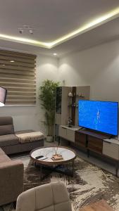 a living room with a large flat screen tv at Empire M in Kinshasa