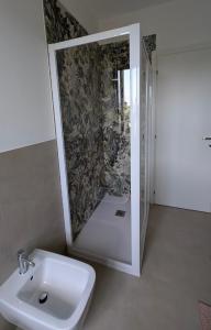 a bathroom with a sink and a shower at Lake Garda Renovated Apartment in Torri del Benaco