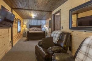 a living room with a couch and a bedroom at Rustic Cabin Retreat - Hot tub - Fire pit - BBQ - in Island Park