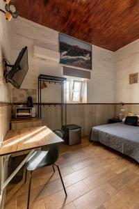 a bedroom with a bed and a desk with a desk at VALTISYA POOL AND AIRPORT in Telde