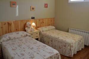 a bedroom with two beds and a teddy bear at Casa Dobón in Castralvo