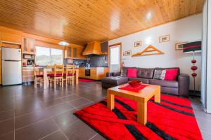 a living room with a couch and a table at Casa da Vigia in Calheta de Nesquim