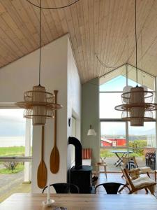 a dining room with wooden utensils hanging from the ceiling at Summer House With Panoramic View Near Doverodde in Doverodde +21 photos