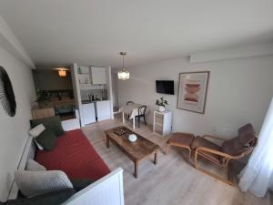 a living room with a couch and a table at Charmant studio in Russan