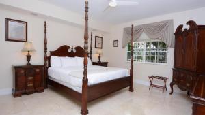a bedroom with a four poster bed and a window at 124 Mariners Club in Key Largo +37 photos