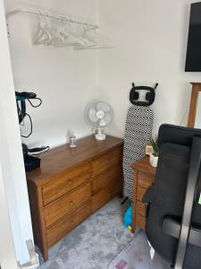 a room with a dresser and a desk with a chair at Cosy living space in Orgreave +7 photos