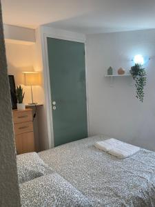 a bedroom with a bed and a closet and a door at Apt cosy centre ville in Laval