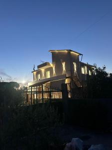 a large house with its lights on at Villa Aliaj in Vlorë