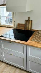 a kitchen with a counter top with a microwave at Bright Summer House Near Hyllingebjerg Beach in Melby