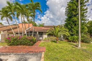 a house with palm trees and a yard at NEW Pool Home with King Bed Mins to Hospital and Beach in Fort Lauderdale