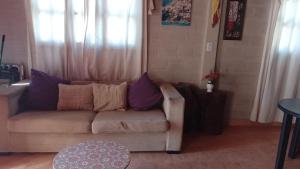 a living room with a couch and a table at Cabaña Sol&Luna in Tafí del Valle