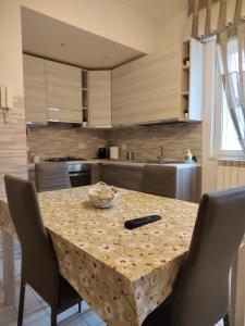 a kitchen with a table with chairs and a sink at La casa di Donatella in Naples +26 photos