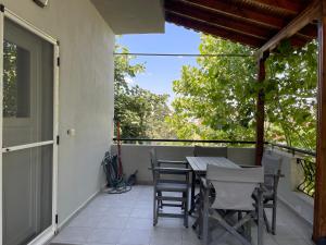 a patio with a table and chairs on a balcony at Villa Maria in Ofrínion