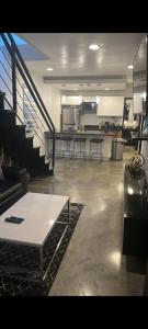 a large living room with a table and stairs at Luxury 3br Private Rooftop in Medellín