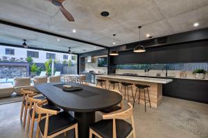 a kitchen with a table and chairs and a counter at Luna Villa Palm Cove in Palm Cove