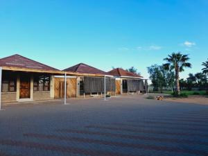 a building with a driveway in front of it at Duineveld Self Catering Cottage in Kalkrand