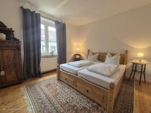 a bedroom with a bed and a large window at Ferienhaus Bärbel Großes Ferienhaus nahe Quedlinburg in Ditfurt