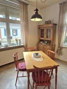 a dining room with a wooden table and chairs at Ferienhaus Bärbel Großes Ferienhaus nahe Quedlinburg in Ditfurt +24 photos