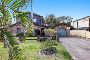 a brick house with a garage and a driveway at Sandy Feet at Hat Head - No Sheets or Towels Provided in Hat Head