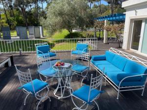 a patio with a blue couch and chairs and a table at Villa Colares in Sintra