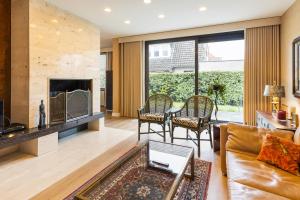 a living room with a couch and a fireplace at Villa Gloria in Ostend
