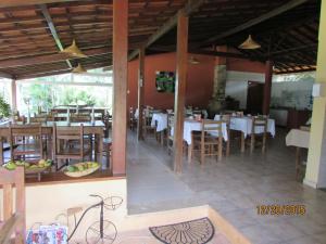 a restaurant with tables and chairs in a room at Pousada Alto do Bau in Conceição do Mato Dentro