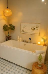 a large white bath tub in a bathroom at Lá Me Homestay in Phú Hiệp