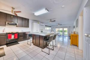 a kitchen with a large island with chairs in it at Quiet Beach Escape in George Town