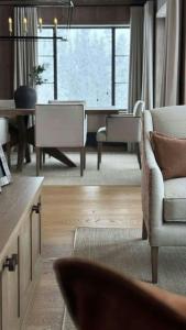 a living room with a couch and chairs and a table at Premium Cabin By Kvitfjell Ski Slopes in Ringebu +1 photo
