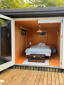 a bedroom with a bed on a wooden deck at Family Idyll Near Kattegat In Tisvilde in Tisvildeleje