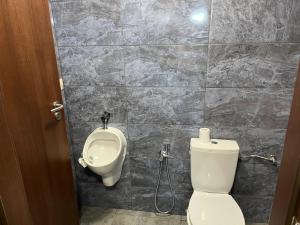 a bathroom with a toilet and a urinal at The Byala Escape, Private Villa with Bar & Hot Tub in Byala