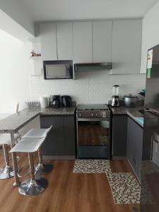 a kitchen with a stove and a counter top at Lovely & quiet place, park view & private parking in Lima